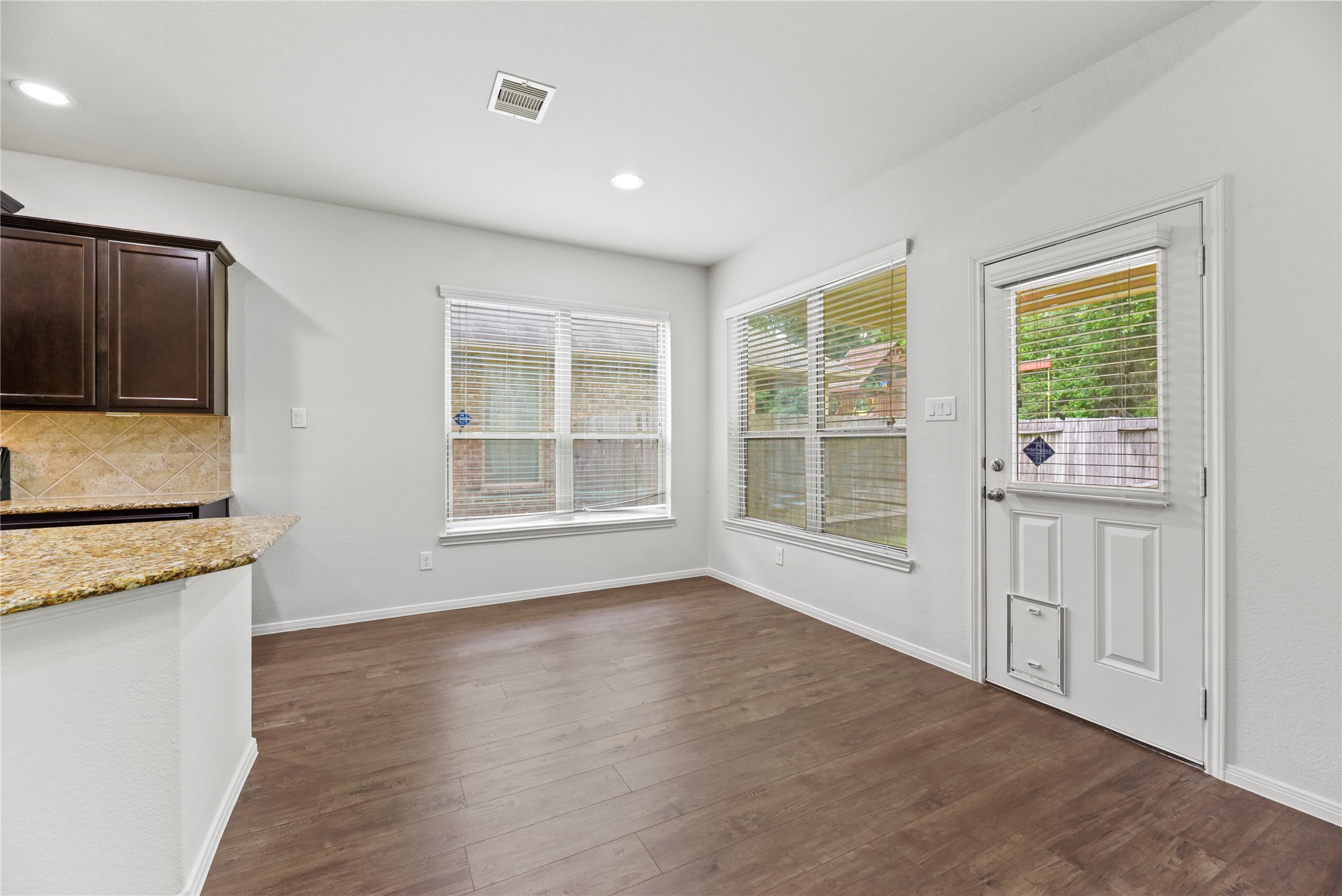 22514 Forbes Field Trail Spring, TX 77389 - Photo 13 of 37 a view of a kitchen with wooden floor and cabinets
