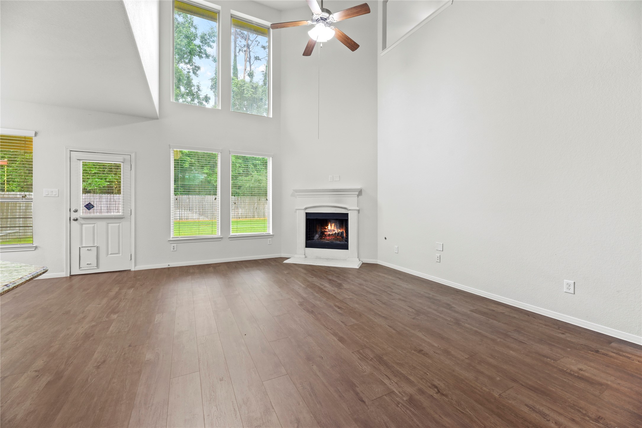 22514 Forbes Field Trail Spring, TX 77389 - Photo 15 of 37 an empty room with wooden floor a ceiling fan and windows