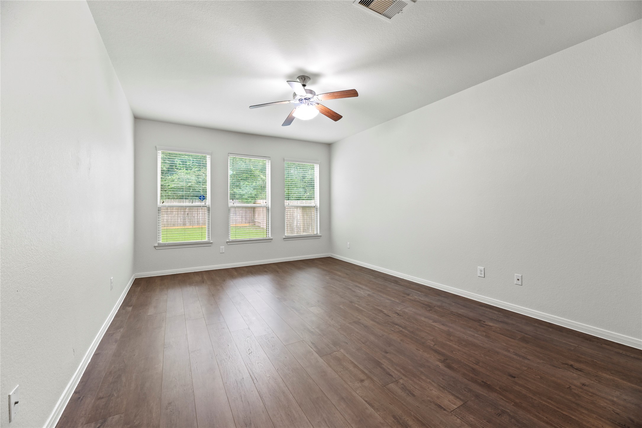 22514 Forbes Field Trail Spring, TX 77389 - Photo 19 of 37 an empty room with wooden floor chandelier fan and windows