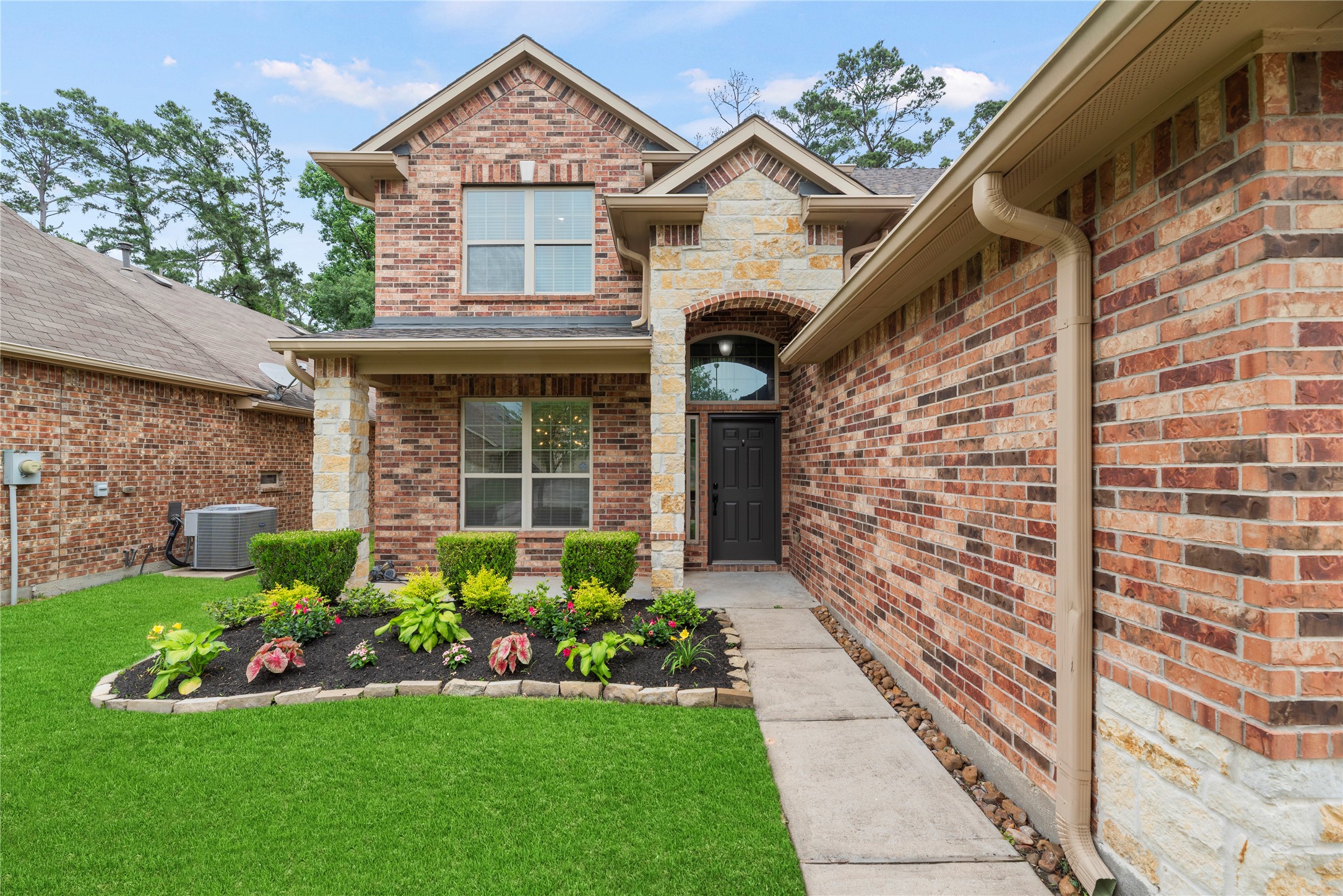 22514 Forbes Field Trail Spring, TX 77389 - Photo 36 of 37 a front view of a house with a garden and plants