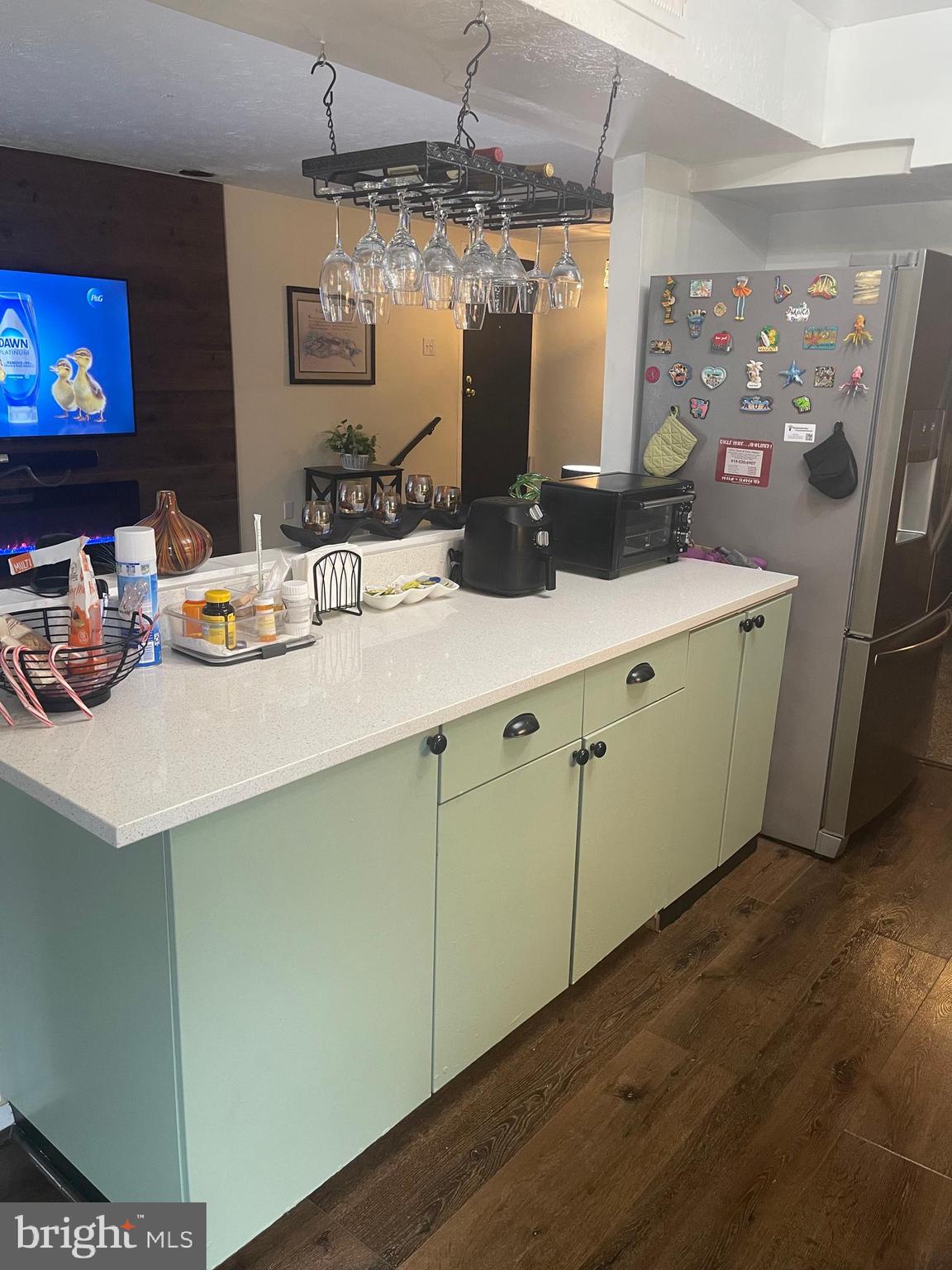 8015 Mandan Road, Unit 202 Greenbelt, MD 20770 - Photo 16 of 52 a kitchen with stainless steel appliances a sink a stove a dining table and chairs