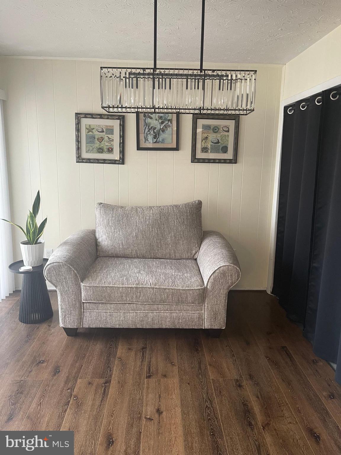 8015 Mandan Road, Unit 202 Greenbelt, MD 20770 - Photo 21 of 52 a living room with furniture a rug and a wall painting