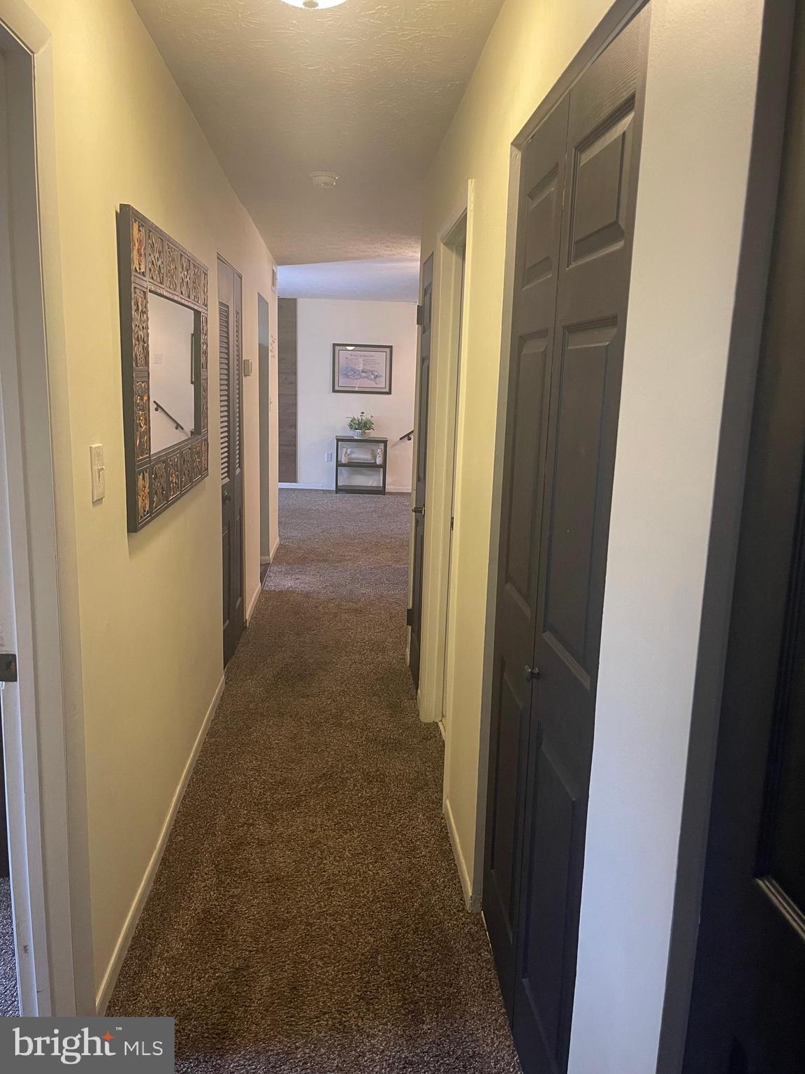 8015 Mandan Road, Unit 202 Greenbelt, MD 20770 - Photo 32 of 52 a view of a hallway to rooms