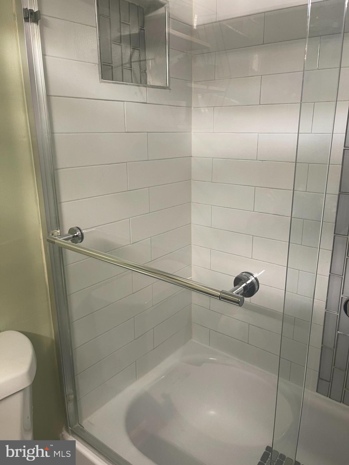 8015 Mandan Road, Unit 202 Greenbelt, MD 20770 - Photo 35 of 52 a bathroom with a shower and toilet