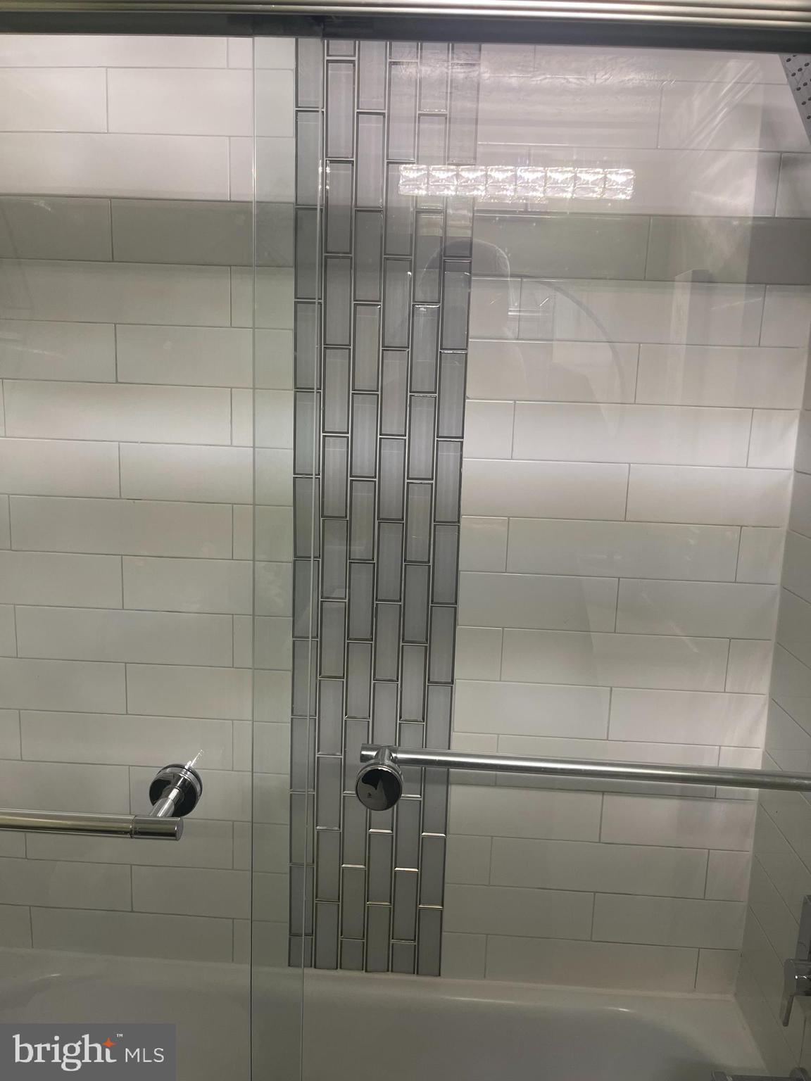 8015 Mandan Road, Unit 202 Greenbelt, MD 20770 - Photo 36 of 52 a bathroom with a glass shower door