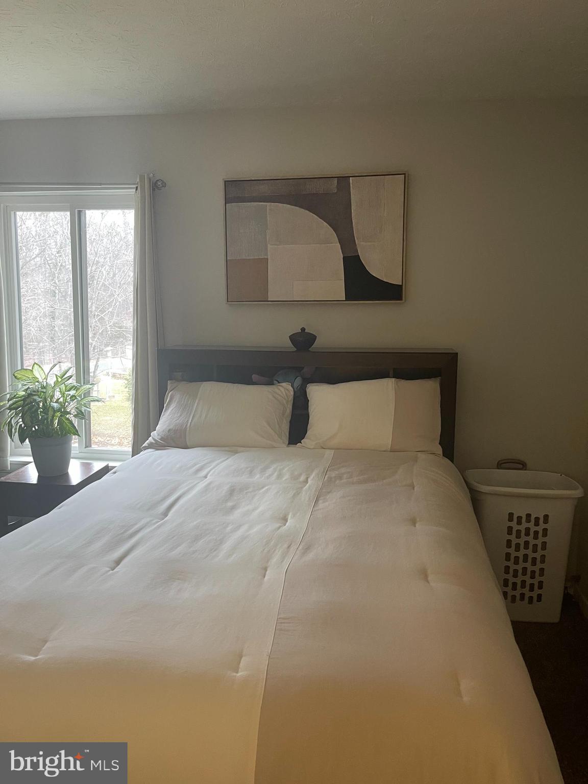 8015 Mandan Road, Unit 202 Greenbelt, MD 20770 - Photo 39 of 52 a bedroom with a bed and a mirror