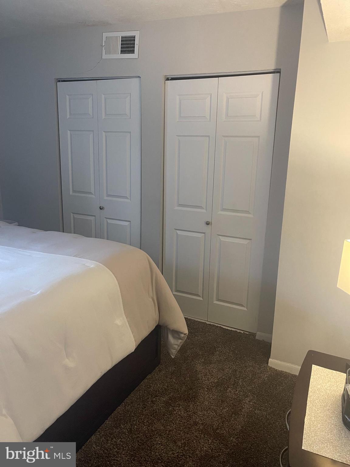 8015 Mandan Road, Unit 202 Greenbelt, MD 20770 - Photo 41 of 52 a bed room with a bed and a chair