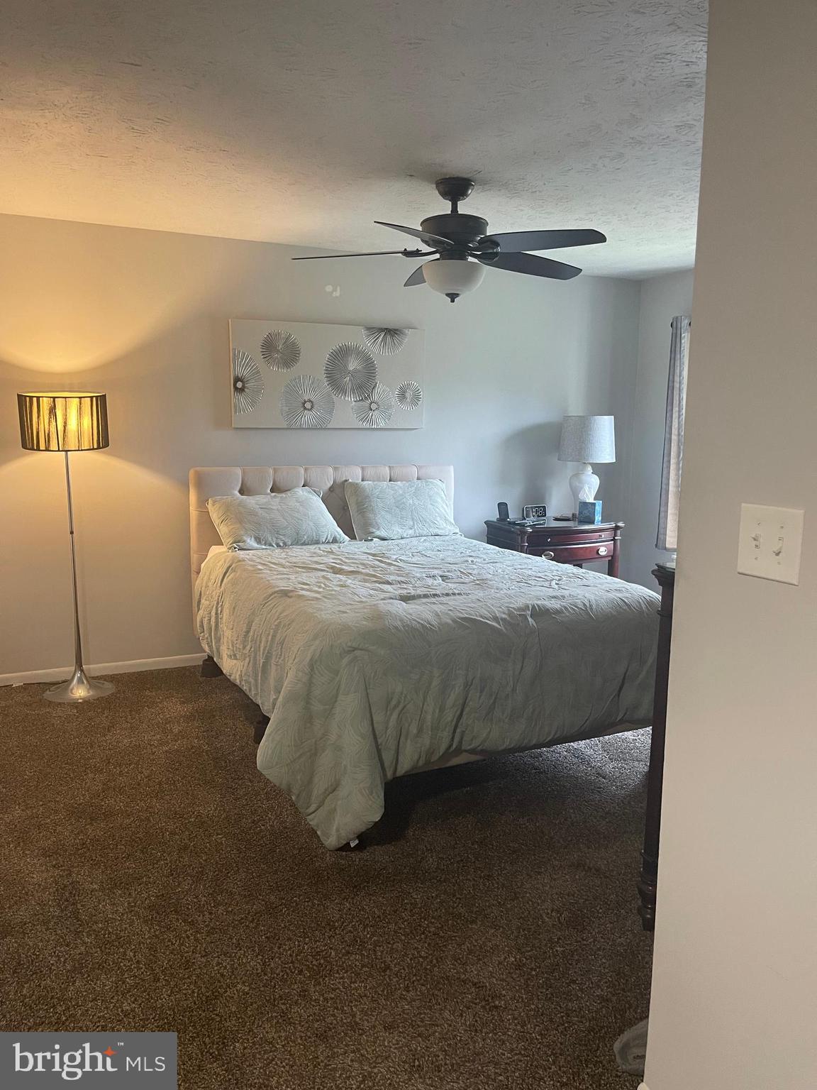 8015 Mandan Road, Unit 202 Greenbelt, MD 20770 - Photo 49 of 52 a bedroom with a bed and a night stand