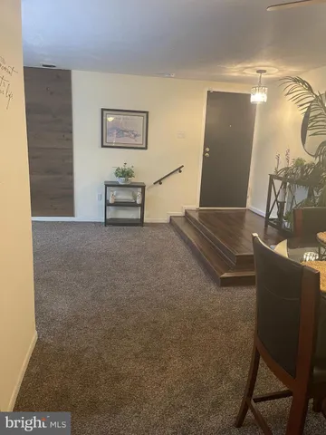 a living room with couch chairs and a table