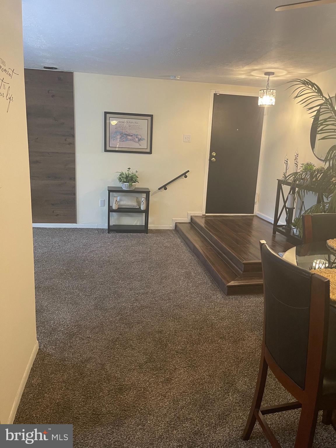 8015 Mandan Road, Unit 202 Greenbelt, MD 20770 - Photo 5 of 52 a living room with couch chairs and a table