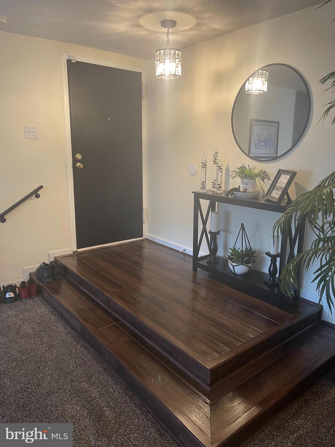 8015 Mandan Road, Unit 202 Greenbelt, MD 20770 - Photo 6 of 52 a room with a chandelier and wooden floor
