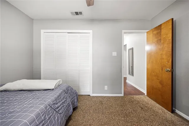 a bedroom with a bed and a mirror