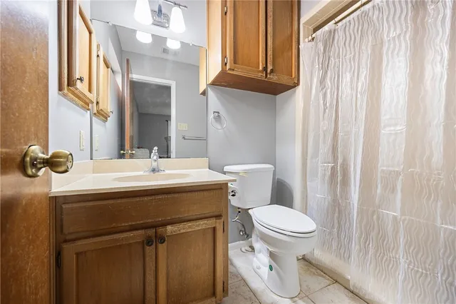 a bathroom with a sink a toilet and a mirror