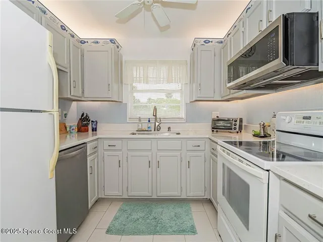a kitchen with appliances cabinets and a sink