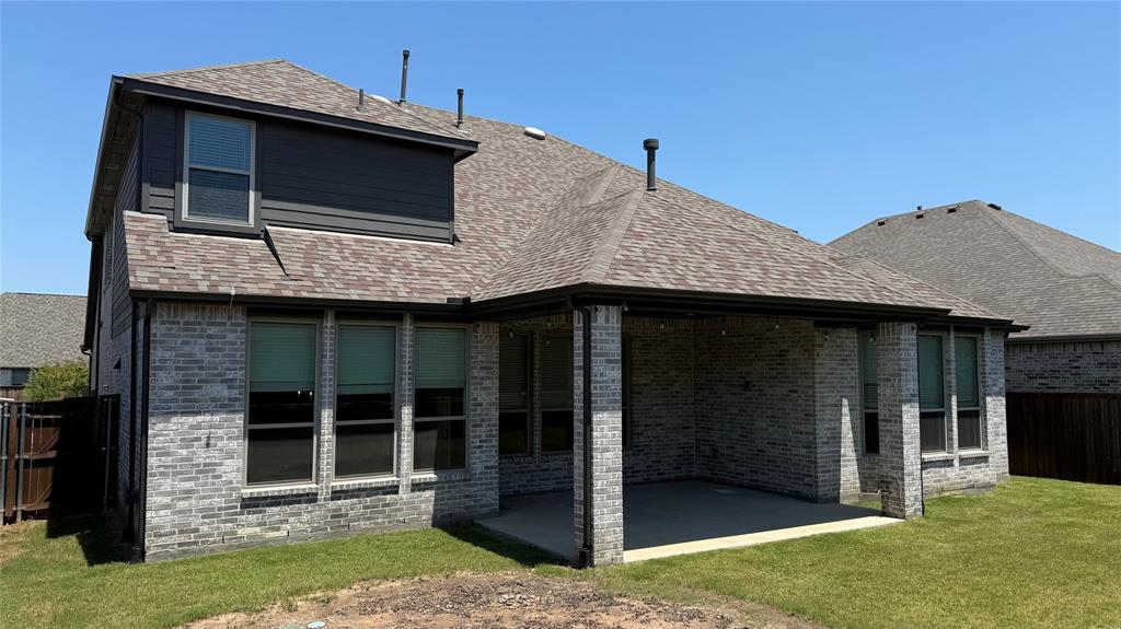 9628 Boulder Pt Road Oak Point, TX 75068 - Photo 27 of 35 Rear exterior featuring a covered patio with concrete flooring, brick columns, and string lighting