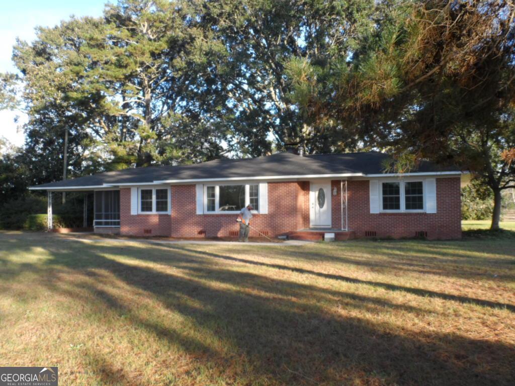 590 Nesbit Road Odum, GA 31555 - Photo 1 of 1 a view of a yard in front of a house with a large tree
