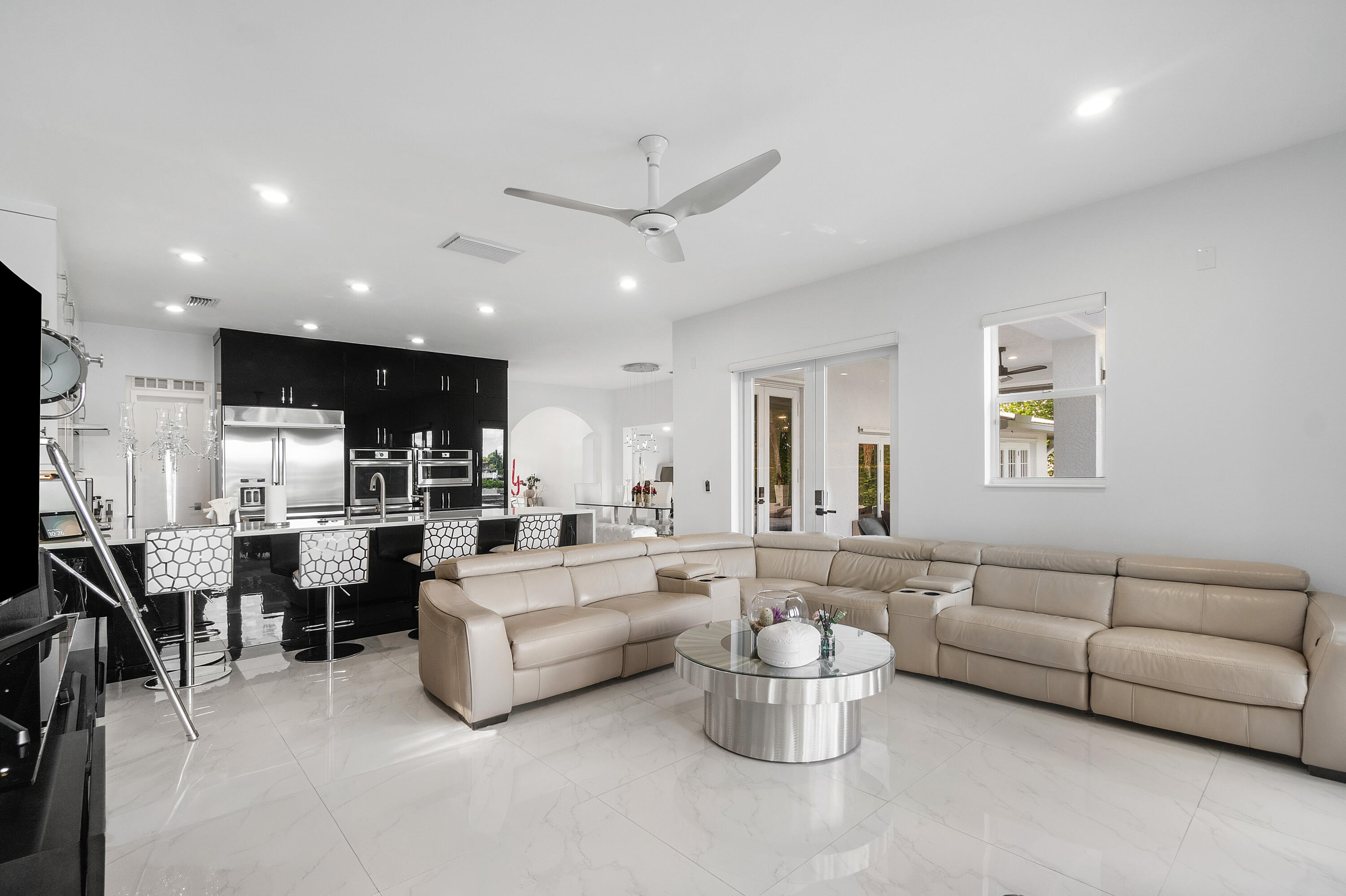 5447 Center Street Jupiter, FL 33458 - Photo 17 of 60 a living room with lots of furniture and white walls