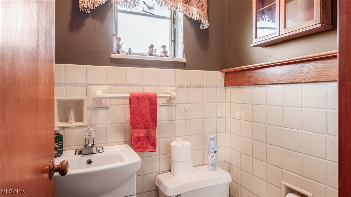 1950 Newark Road Zanesville, OH 43701 - Photo 16 of 39 Bathroom with sink, toilet, and tile walls