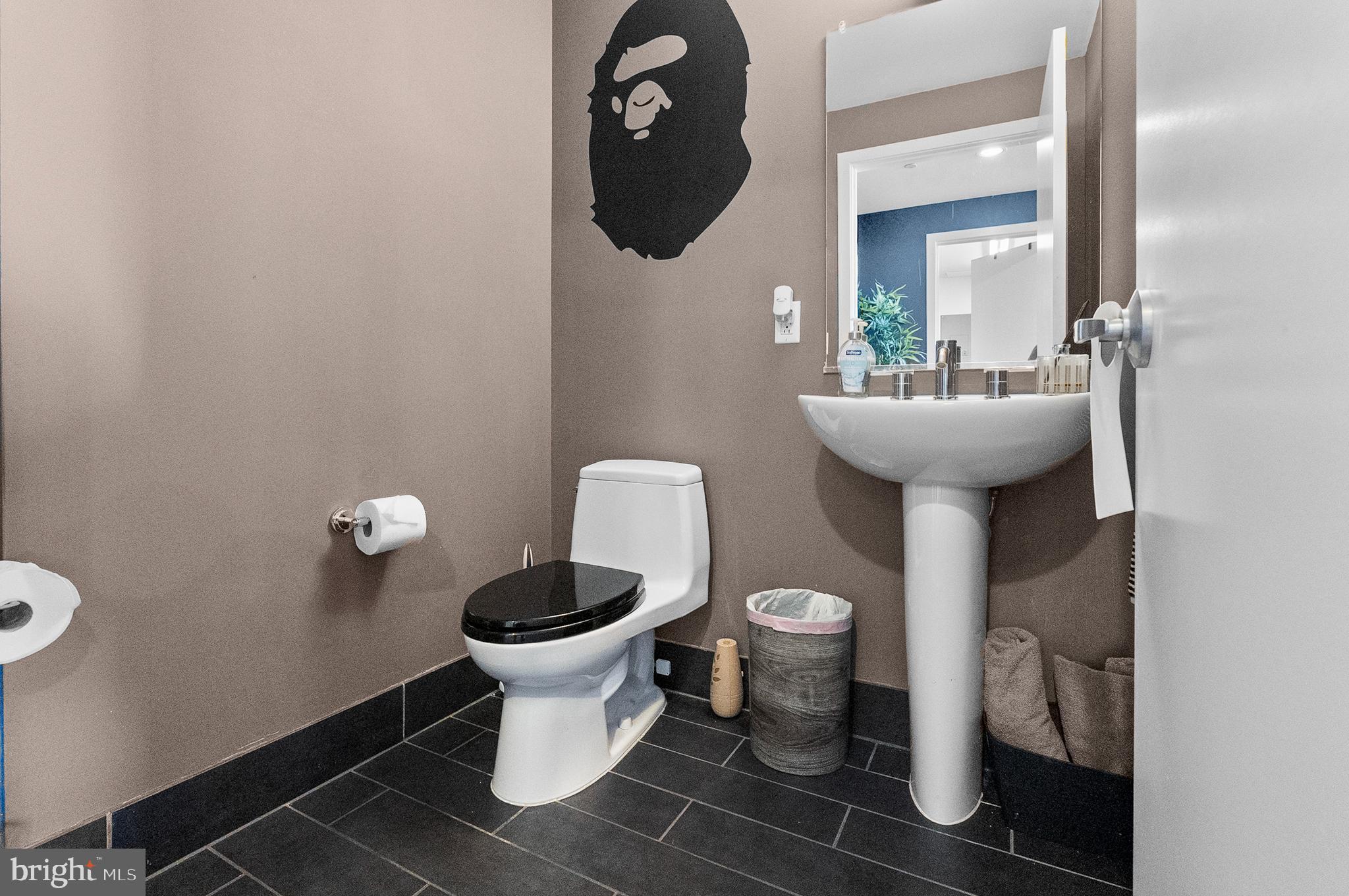 1200 Steuart Street, Unit 530 Baltimore, MD 21230 - Photo 12 of 38 a bathroom with a toilet sink and mirror