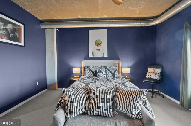 a bedroom with a bed and a lamp