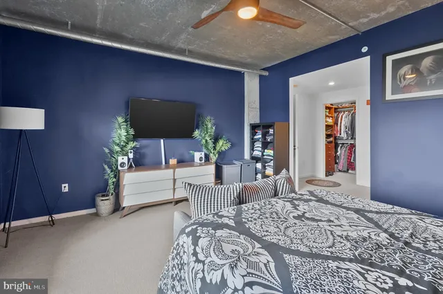 a bedroom with a bed and a couch