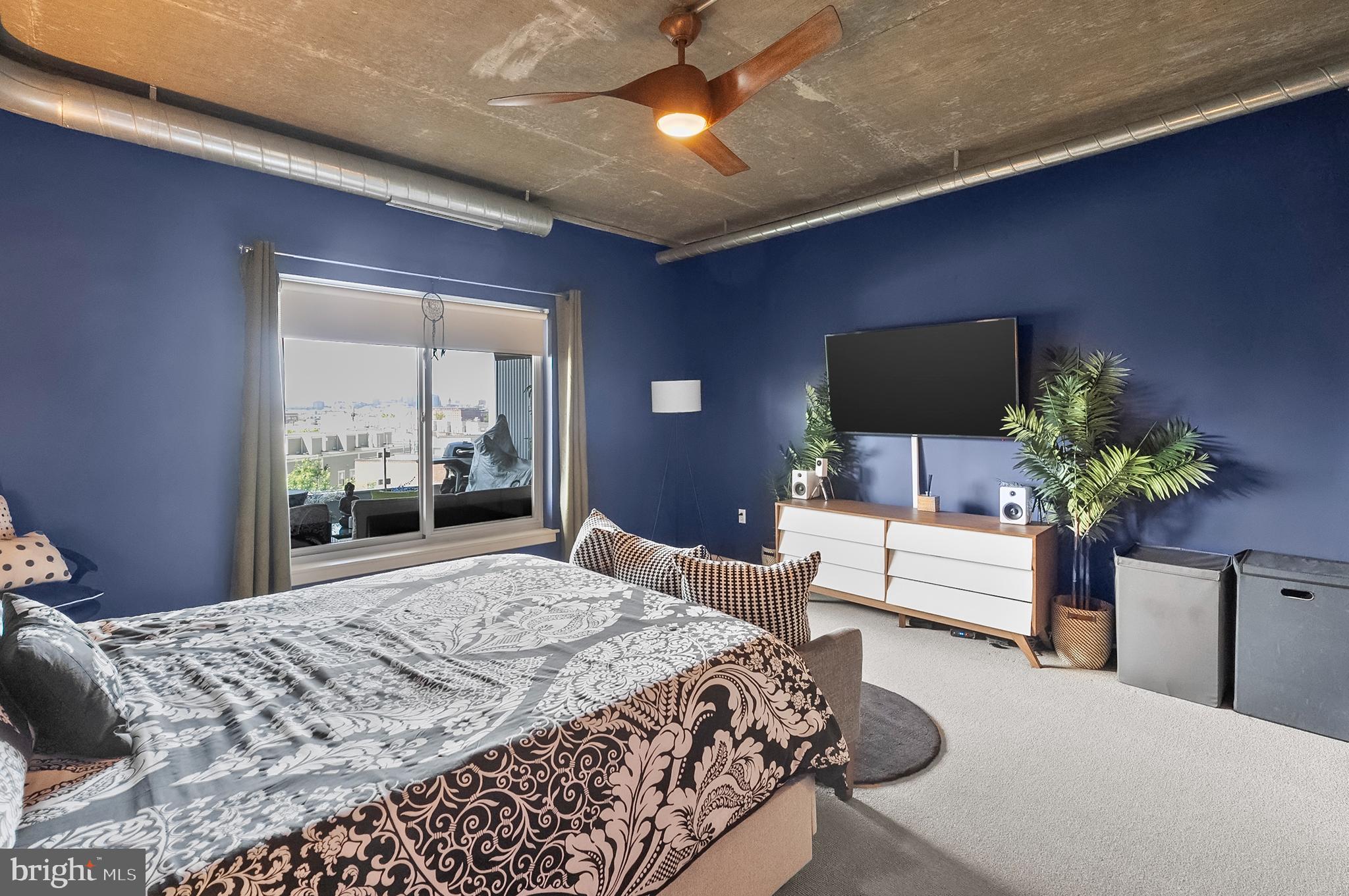 1200 Steuart Street, Unit 530 Baltimore, MD 21230 - Photo 16 of 38 a bedroom with a bed and a flat screen tv