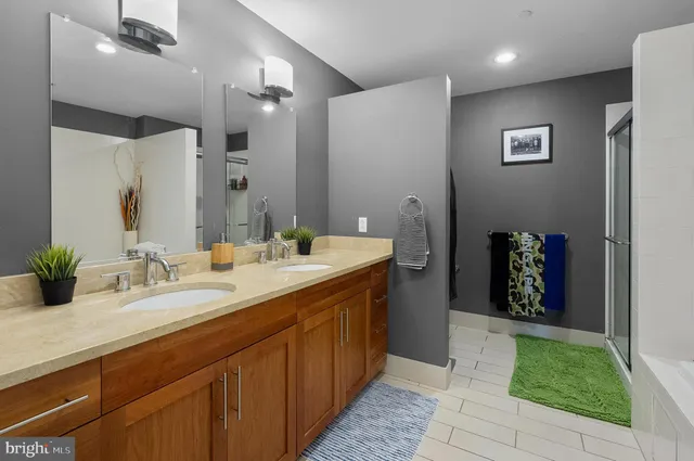 a spacious bathroom with a double vanity sink and a mirror