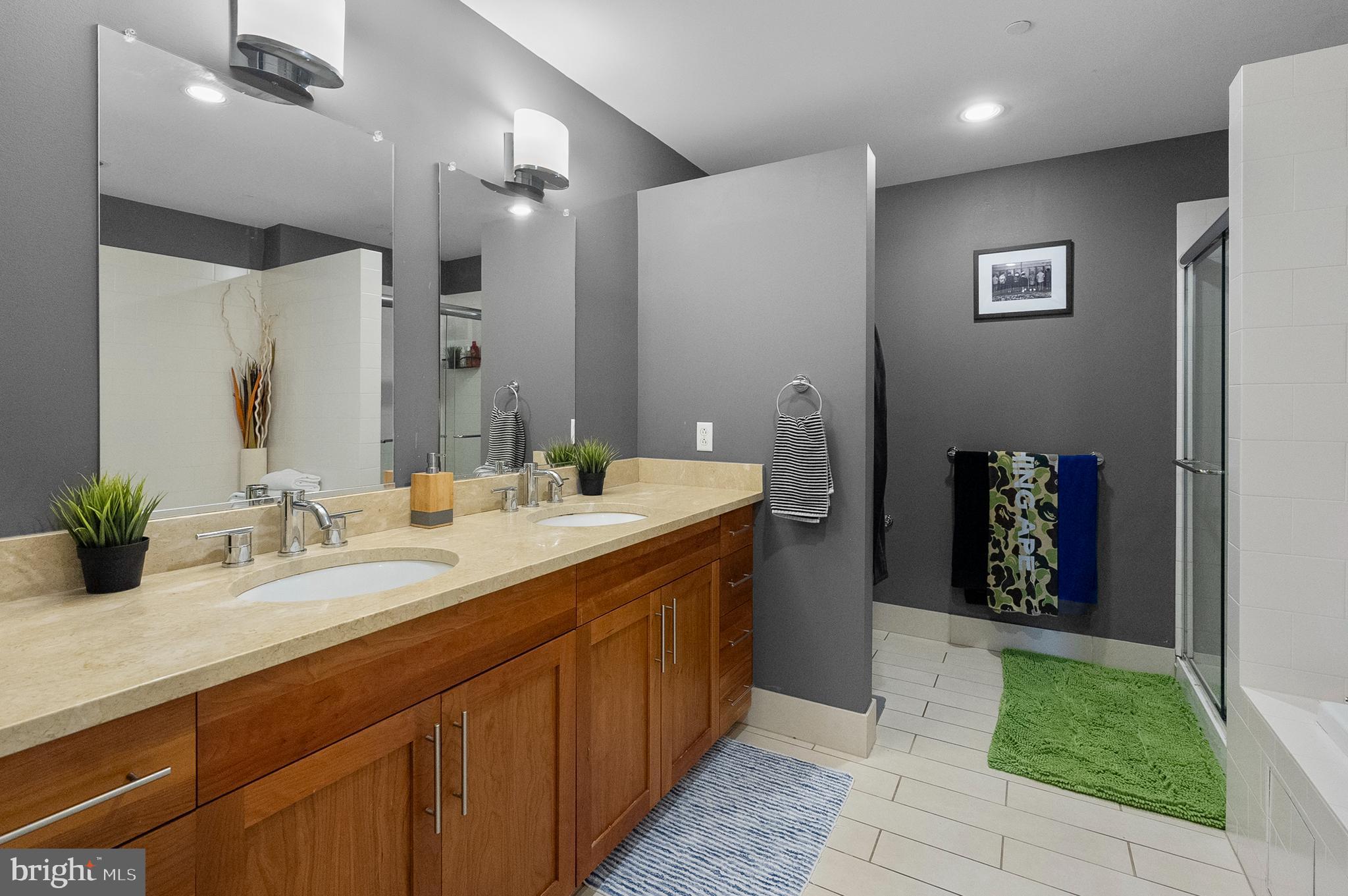1200 Steuart Street, Unit 530 Baltimore, MD 21230 - Photo 17 of 38 a spacious bathroom with a double vanity sink and a mirror