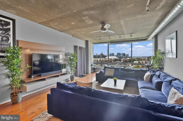 a living room with furniture and a flat screen tv