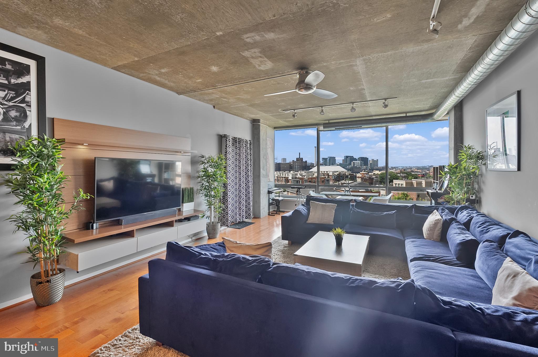 1200 Steuart Street, Unit 530 Baltimore, MD 21230 - Photo 2 of 38 a living room with furniture and a flat screen tv