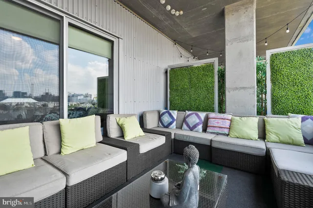 a outdoor living room with furniture and a large window