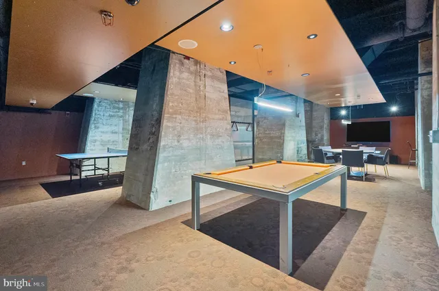 a room with pool table and windows