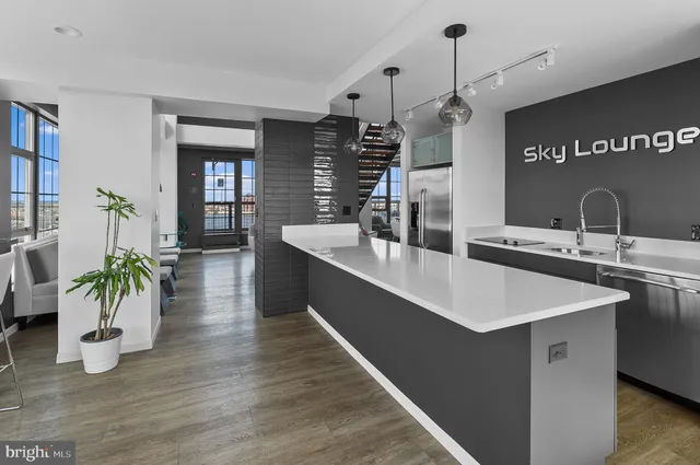 a living room with furniture floor to ceiling window and wooden floor