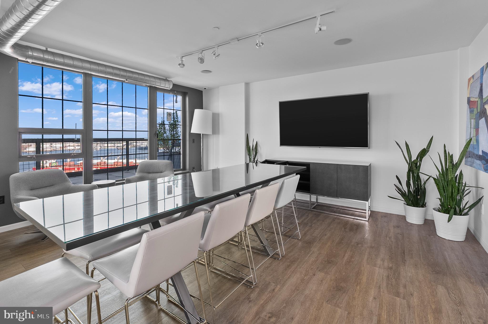 1200 Steuart Street, Unit 530 Baltimore, MD 21230 - Photo 35 of 38 a living room with furniture floor to ceiling window and wooden floor