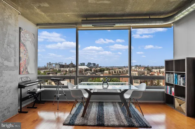 a living room with furniture pool view and large windows