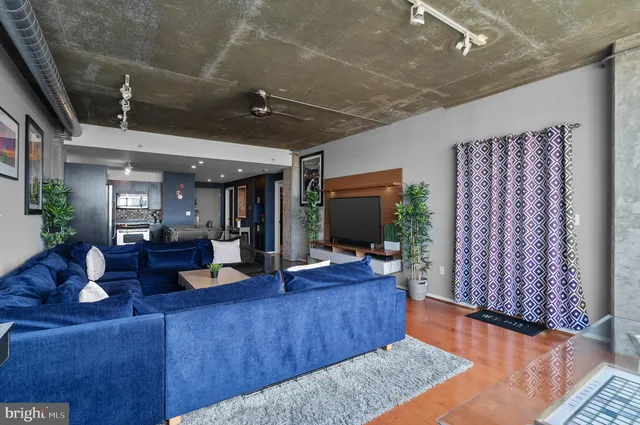 a living room with furniture and a flat screen tv