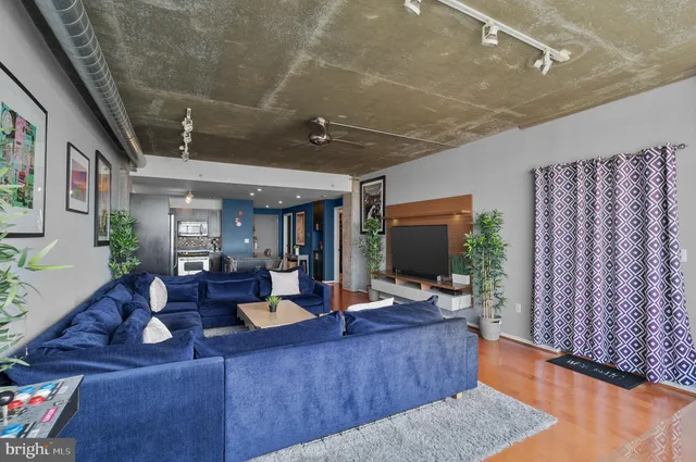 a living room with furniture and a flat screen tv