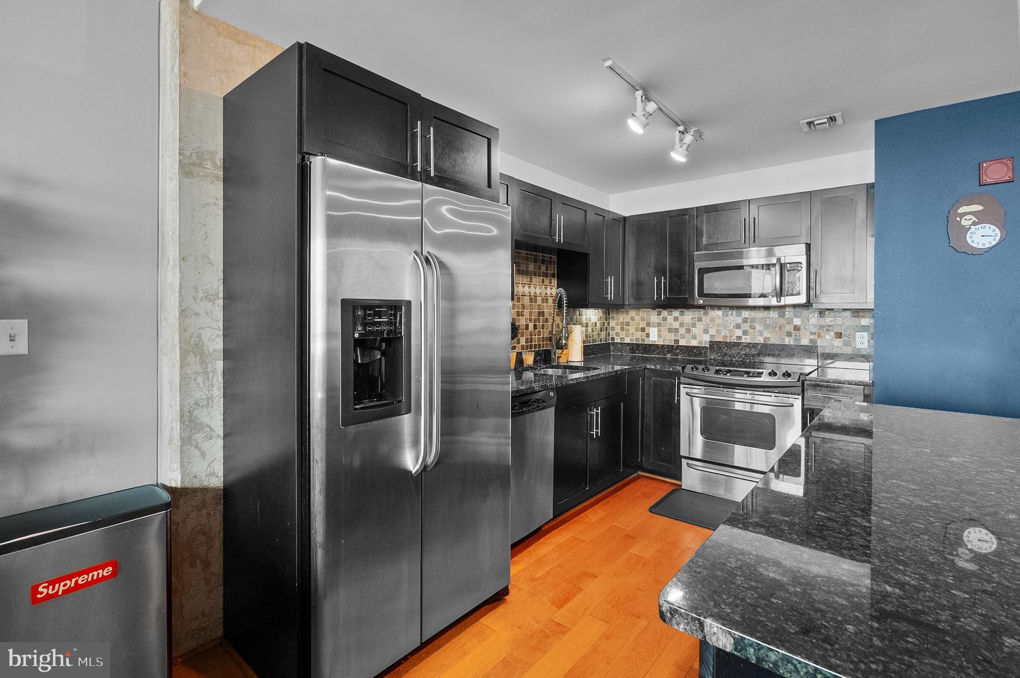 1200 Steuart Street, Unit 530 Baltimore, MD 21230 - Photo 10 of 38 a kitchen with stainless steel appliances granite countertop a refrigerator stove and oven