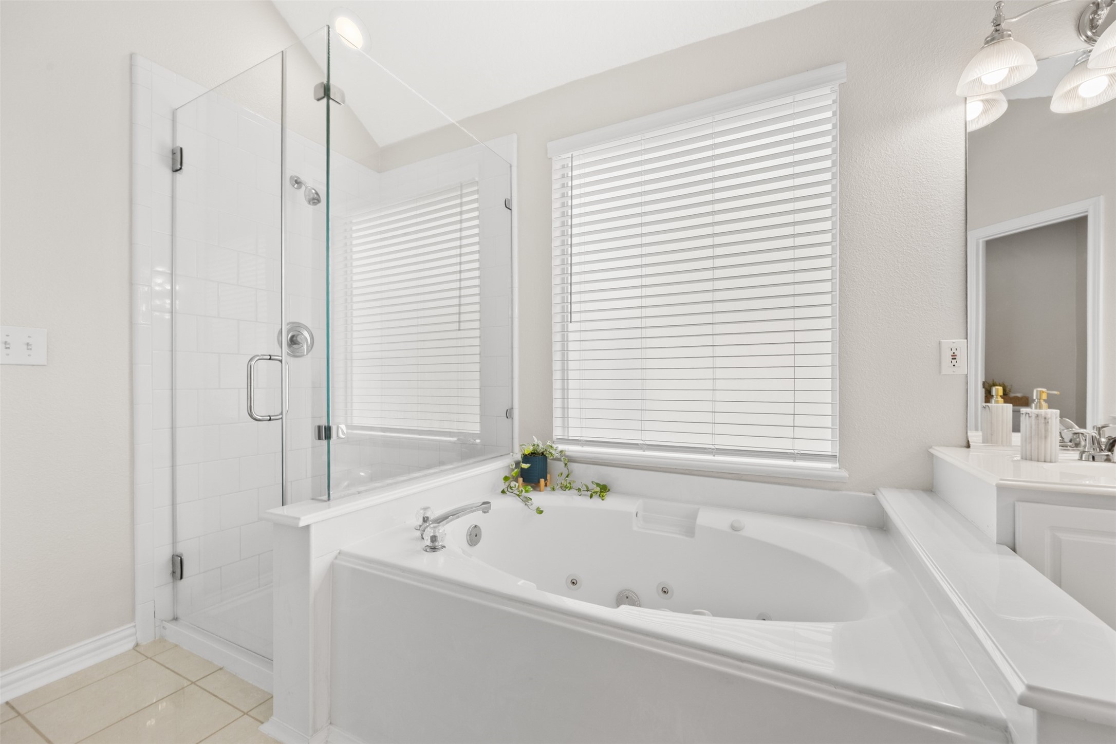 2219 Louetta Brook Lane Spring, TX 77388 - Photo 27 of 34 Relaxing jetted soaking tub with natural light and adjacent walk-in shower.