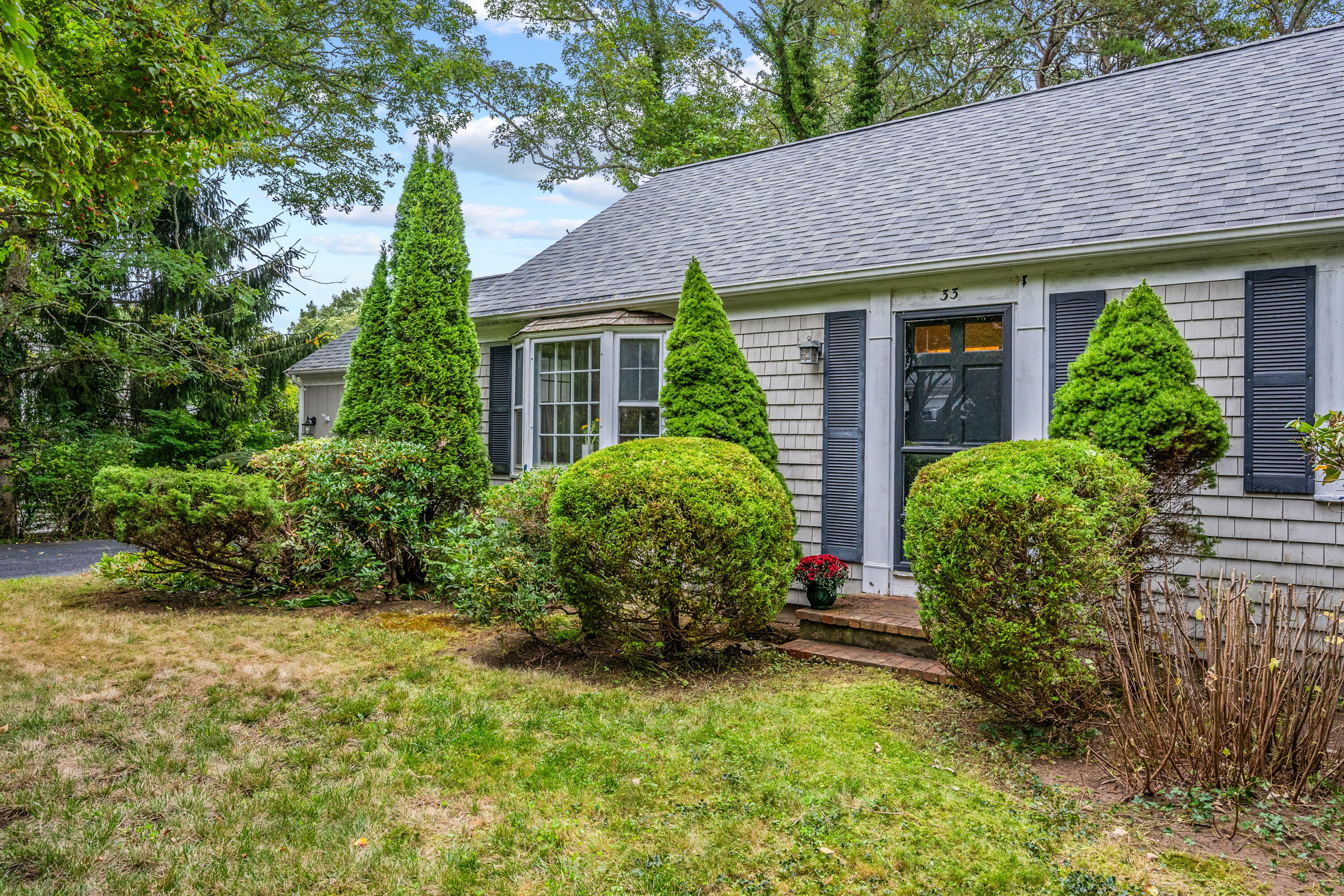 33 Oxner Road Centerville, MA 02632 - Photo 3 of 26 a front view of house with yard and green space