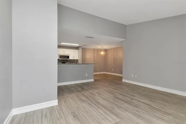 a view of a kitchen with wooden floor and a sink