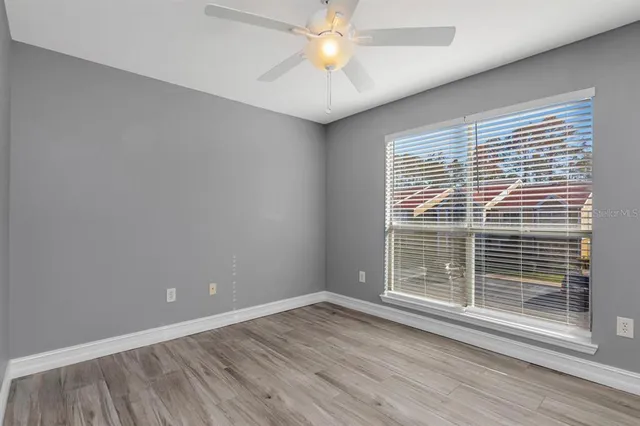 a view of a livingroom with a ceiling fan and window