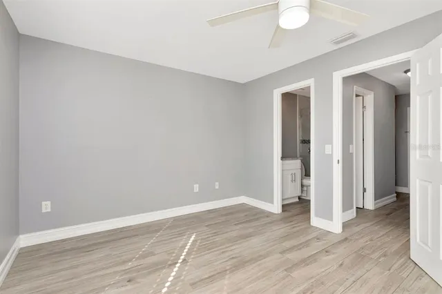 a view of an empty room with wooden floor
