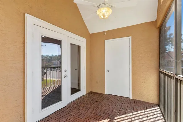 a view of a room with wooden floor and a window