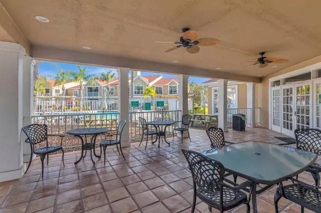 a view of a dining room with furniture large windows and wooden floor