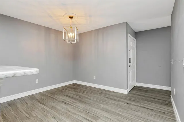 a view of a room with wooden floor and white walls