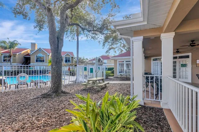 a view of a house with backyard and porch
