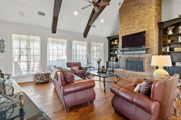 a living room with fireplace furniture and a flat screen tv