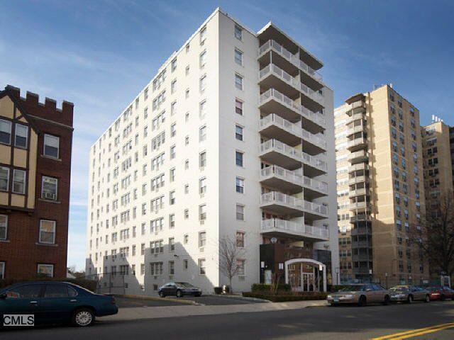 30 Glenbrook Road, Unit 2H Stamford, CT 06902 - Photo 1 of 1 a tall building sitting on the side of a street