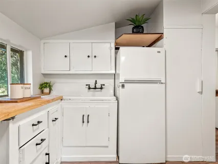 a stove top oven sitting inside of a kitchen